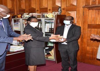 Clerk to Parliament, Ms Jane Kibirige (2nd L) handsover Shs30 million to Dr. Samuel Guma, the Executive Director at New Hope Children’s Hostel. (Left) is the Deputy Clerk to Parliament, Mr. Henry Waiswa (left) and (right) is Henrieta Kebirungi, Resource Mobiliser of New Hope Children’s Hostel