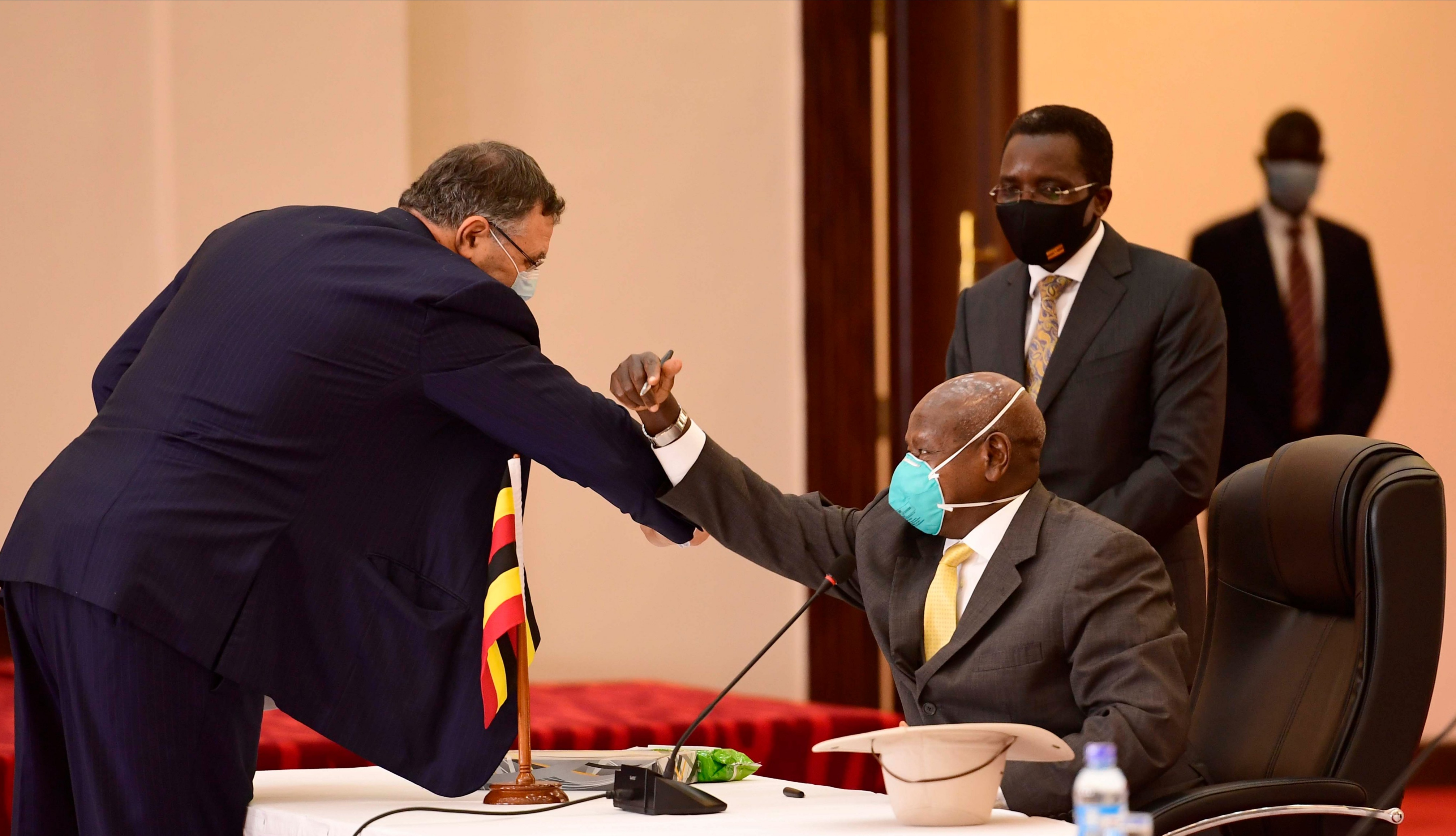 Total E&P President and Chief Executive Officer Patrick Pouyanne greets President Yoweri Museveni during the signing of three key oil and gas agreements