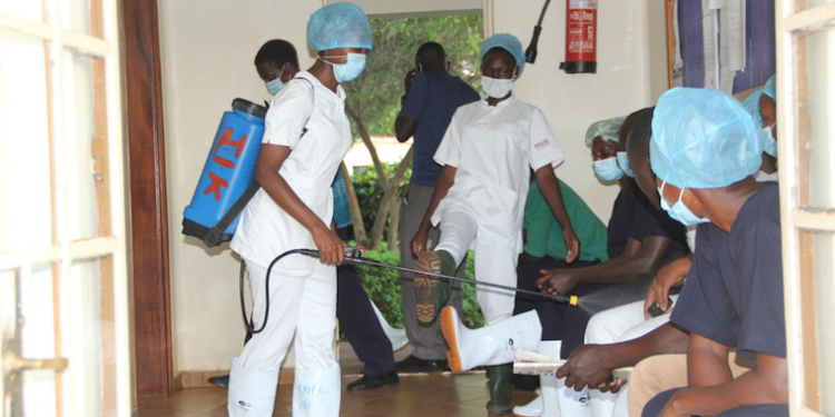 Health workers sanitizing before treating Covid-19 patients