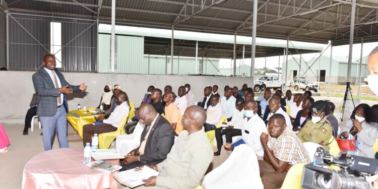 The Head of the industrial hubs and Presidential projects in Uganda Eng. Kamugisha Raymond (left) giving a lecture during a meeting that was being attended by Political leaders from BukedI Sub-region in Lwatama Village in Kibuku District at the Presidential Initiative For Industrial Zonal Hub Bukedi Sub-region on 13th April 2022. Photo by PPU / Tony Rujuta.