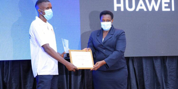 H.E Jessica Alupo, The Vice President of Uganda Awarding Olinga John Peter, Huawei Instructor who led the Uganda team to take first position in Africa Region