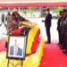 President Yoweri Museveni laying a wreath on Keith Muhakanizi's body