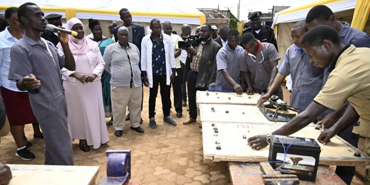 A student of mechanics at the Presidential Initiative on skilling the Girl/Boy Child (PISG/B) demonstrates to a guest on how they have learnt in motor wiring garden at the PISG/B Wabigabo branch in Kampala on 12th September 2023. Photo by PPU/ Tony Rujuta.