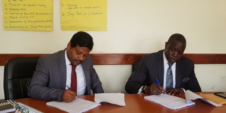 Ediga Udai Kanth - Africa head for Dataset Solutions and Sisto Ocanda Ondama, CEO Paramount Cities, USA signing the contract with Jinja City in 2020.