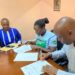 From left: Gad Kwizera (Assist. Agriculture Lecturer, Lira University), Nancy Mugimba (National Coordinator, ESAFF Uganda), and Hakim Baliraine (National Chairperson, ESAFF Uganda) sign an MoU to spearhead agroecology study programs at Lira University.