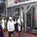 Francis Mugabe (2nd R), proprietor of Kike Tropical Fruit factory in Kakooge, Nakasongola and his team take President Museveni on a guided tour of the factory shortly after its commissioning on Thursday. PPU