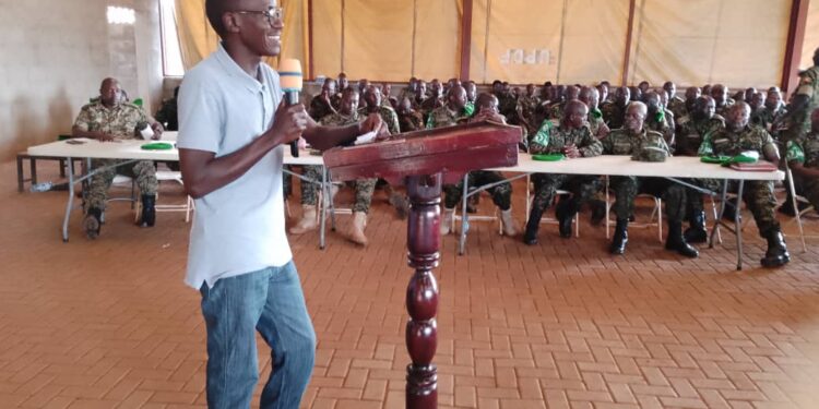 Dr Charles Michael Karimbaka making a presentation to the UPDF officers.