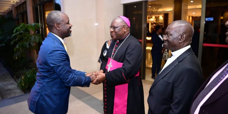 Archbishop Paul Ssemwogerere (centre) welcoming the Deputy Speaker, Thomas Tayebwa, at the Memorial Lecture held at Hotel Africana on Thursday, 07 March 2024