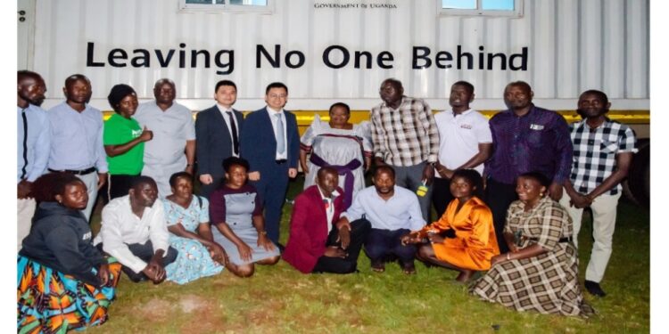 The Prime Minister with officials from Huawei Technologies Uganda and some of the instructors and outstanding students in the DigiTruck Project training in Kakumiro.