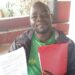 Robert Wesonga, the Group Secretary, holds a copy of the Sale Agreement and a file for the land containing documents in question.