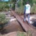 A journalist crossing Nyagak Paa Bruno footbridge that connects Atyak Sub-County  and Nebbi Subcounty recently. The footbridge is reported to have claimed more than 20 lives since  2007.PHOTO/MIKE RWOTHOMIO.