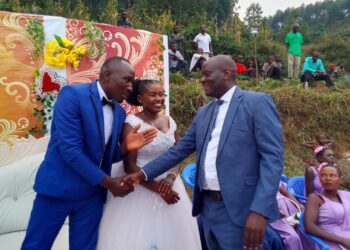 Ampeire Stephen Kasyaba, the Rubanda District LC.5 Chairman with a newly wed couple