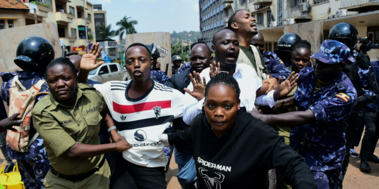 Ugandan police officers detain protestors during a rally against what the protesters say are rampant corruption and human rights abuses by the country's rulers in Kampala, Uganda July 23, 2024. REUTERS/Abubaker Lubowa