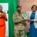 Maj. Gen Sabiiti Muzeeyi. General Manager - Luwero Industries Ltd. NEC, handing over the award to Barbara Dokoria (R) the Stanbic Bank Ag. Executive Director, Looking is Diana Ondoga the bank's head of CS