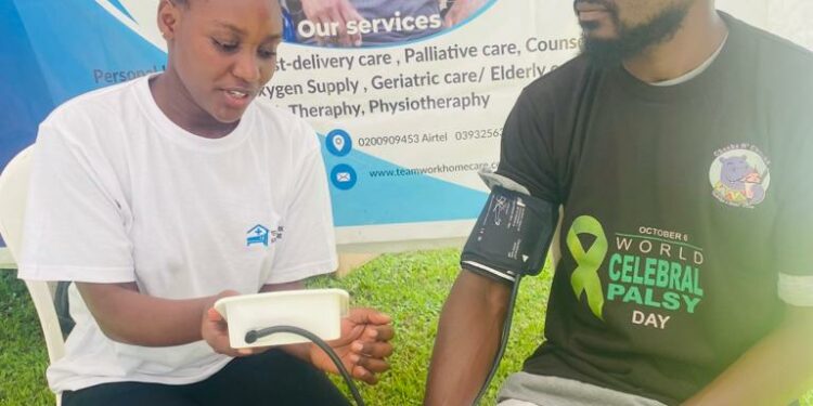 A Nurse in white t-shirt attached to Teamwork Homecare Services takes a Blood Pressure reading of a guest at a recent medical outreach. The firm specialises in management of chronic diseases like Hypertension and the provision of office, home based and emergency medical care to patients