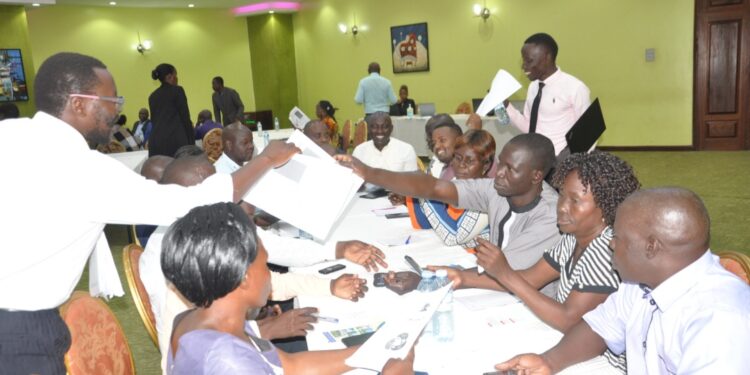 Public Health stakeholders conduct the RCCE Toolkit pre-test exercise at the Imperial Royale Hotel, Kampala City,  under the supervision of USAID SBCA Team . (PHOTO/USAID SBCA)