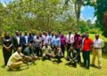 Journalists and radio presenters pose for a group photo after the Mbale meeting.