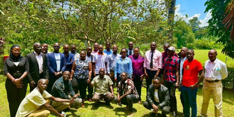 Journalists and radio presenters pose for a group photo after the Mbale meeting.