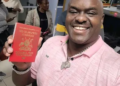 Rugiirwa Katatumba brandishing a red passport a preserve for a few