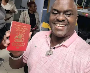 Rugiirwa Katatumba brandishing a red passport a preserve for a few