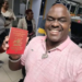 Rugiirwa Katatumba brandishing a red passport a preserve for a few