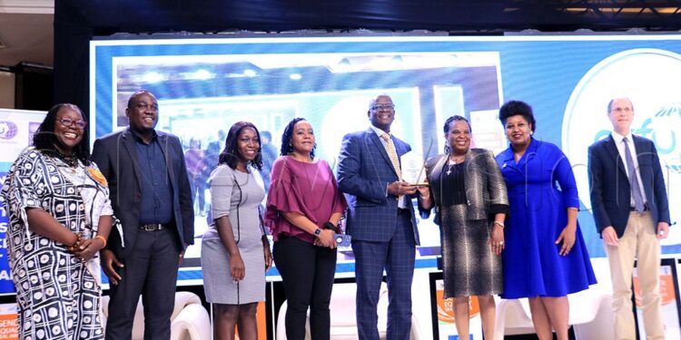 Andrew Kilonze Managing Director Uganda Breweries Limited (forth right) receiving an recognition award from Betty Among Minister of Gender, Labour and Social Development (Third right) during the for Gender Equality Seal Award Ceremony for private Sector companies at Serena Hotel on 8th December 2023. Photo by Ivan Kabuye.