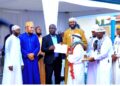 Haji Kirunda handing over a certificate to one of the participants