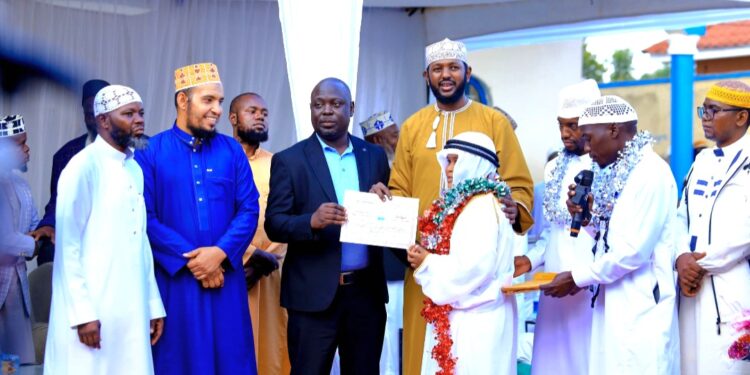 Haji Kirunda handing over a certificate to one of the participants