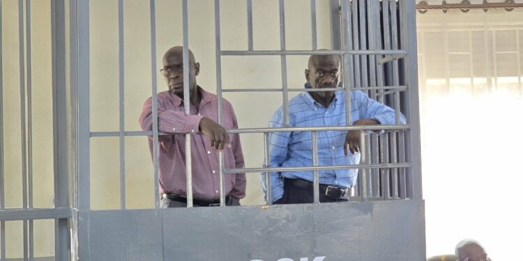 Hajji Lutale and Dr. Kizza Besigye in court dock