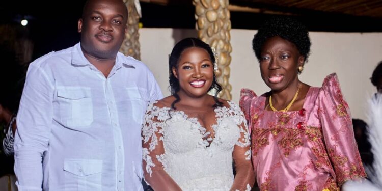 UPDF Capt Michael Arthur Mugisa's new catch Esther Mirembe poses for a photo with Rt Hon Rebecca Alitwala Kadaga shortly after tying the knot.