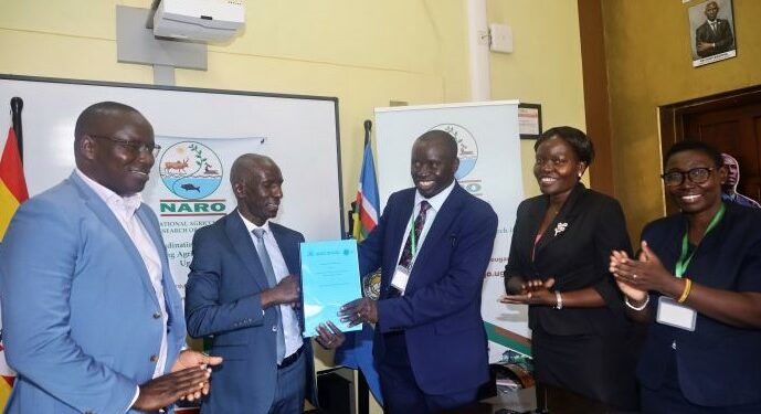 NARO-Director-General-Dr.-Yona-Baguma-and-the-Vice-Chancellor-Busitema-University-Prof.-Waako-exchange-MoUs-after-signing.-Courstesy-photo.jpg